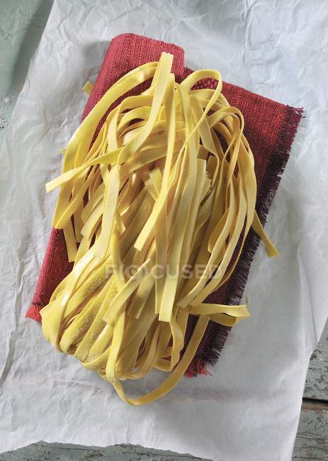 Dried tagliatelle pasta — Stock Photo
