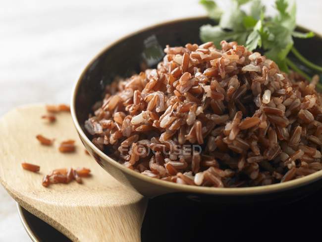 Bowl of cooked red rice — Stock Photo