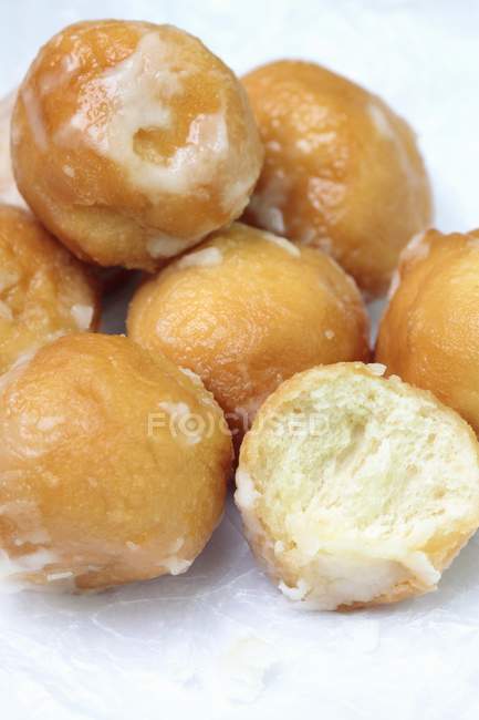 Closeup view of fried dough balls with icing sugar — Stock Photo