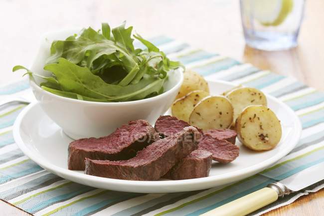 Fried ostrich fillet with rosemary potatoes — Stock Photo