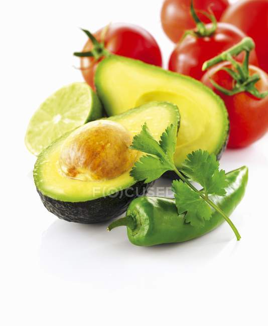 Avocado with tomatoes and chili pepper — Stock Photo