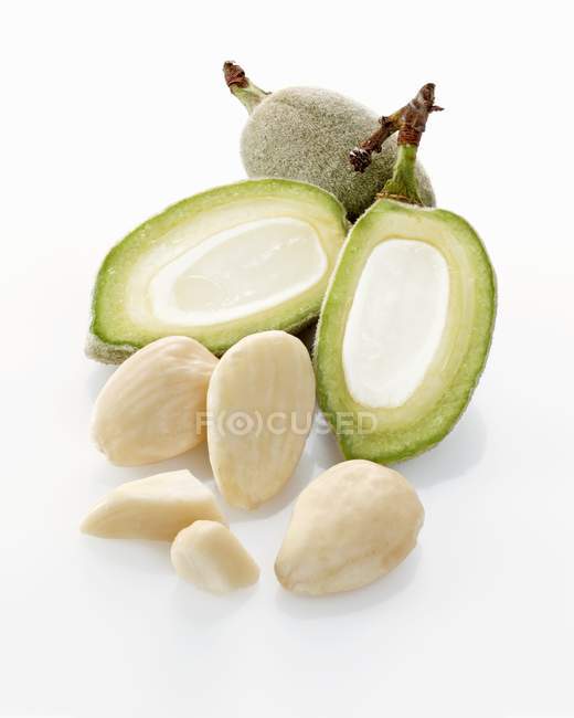 Raw almonds and almond hulls — Stock Photo