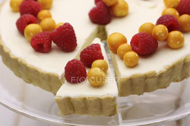 Tart with raspberries on glass plate — Stock Photo