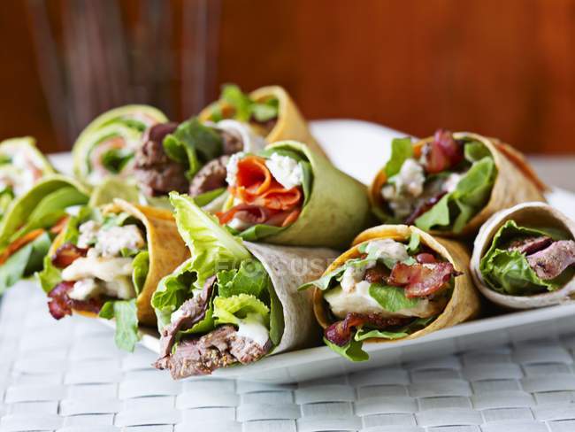 Closeup view of various wraps with vegetables and meat — Stock Photo