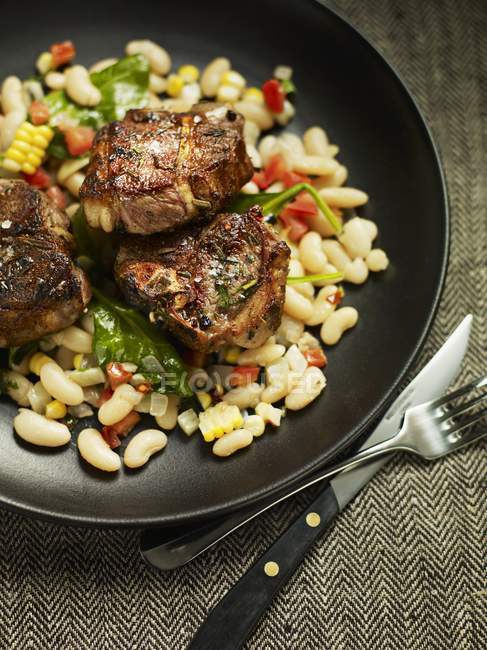 Lamb chops on bean and corn salad — Stock Photo