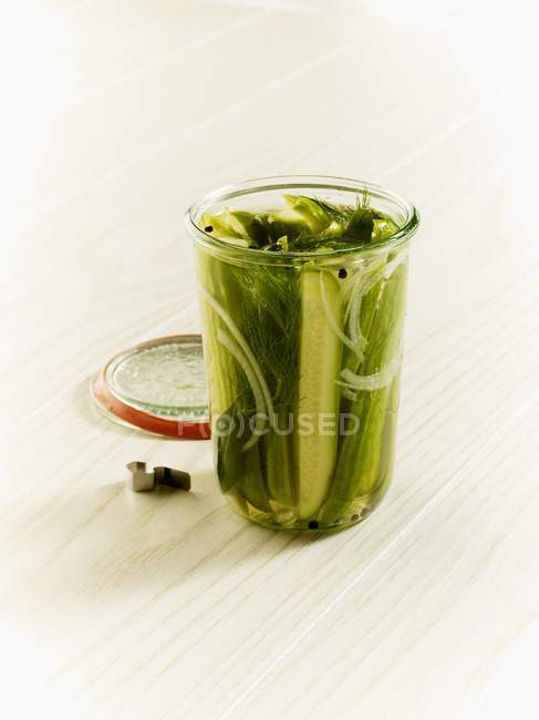 Homemade dill gherkins in open jar — Stock Photo