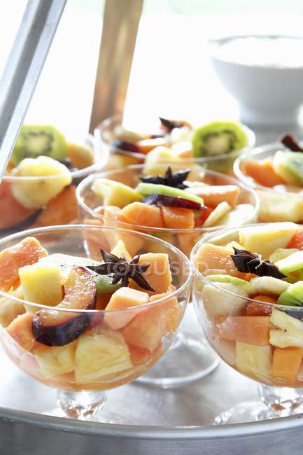 Closeup view of fruit salad with anise stars in glass bowls — Stock Photo