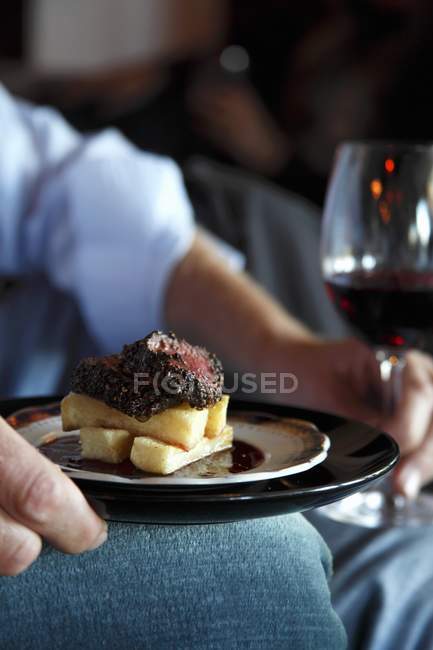 Plate of ostrich steak and potato chips — Stock Photo