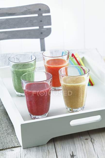 Four smoothies on tray — Stock Photo