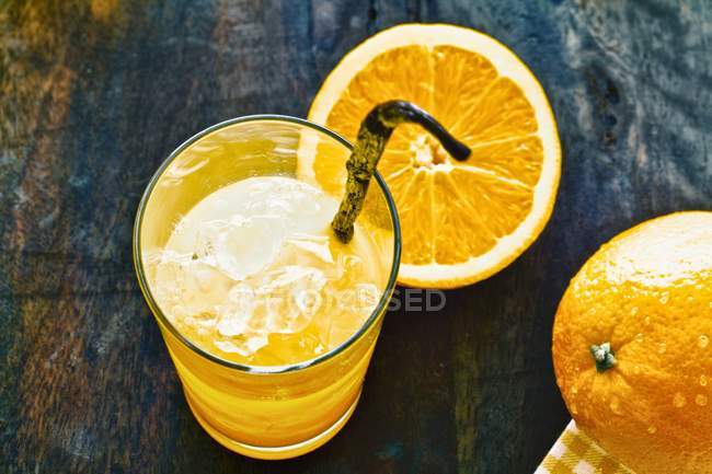 Orange juice with vanilla pod — Stock Photo