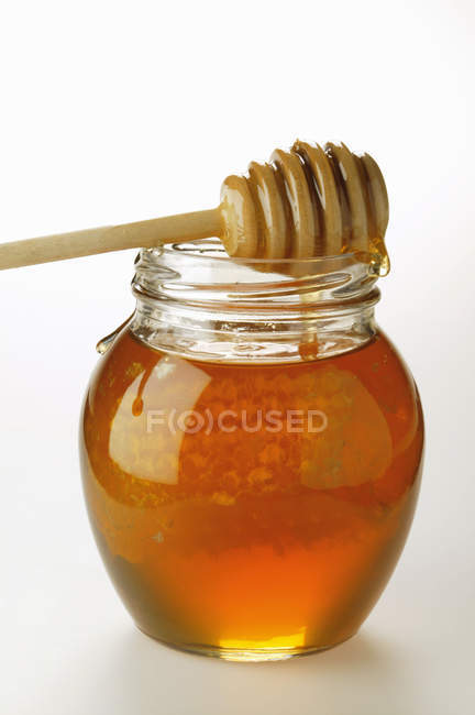 Honey in jar with honeycomb — Stock Photo