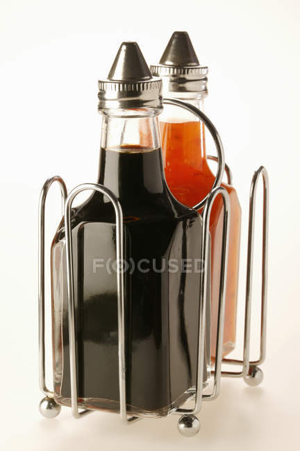 Chili sauce and soy sauce in bottles — Stock Photo