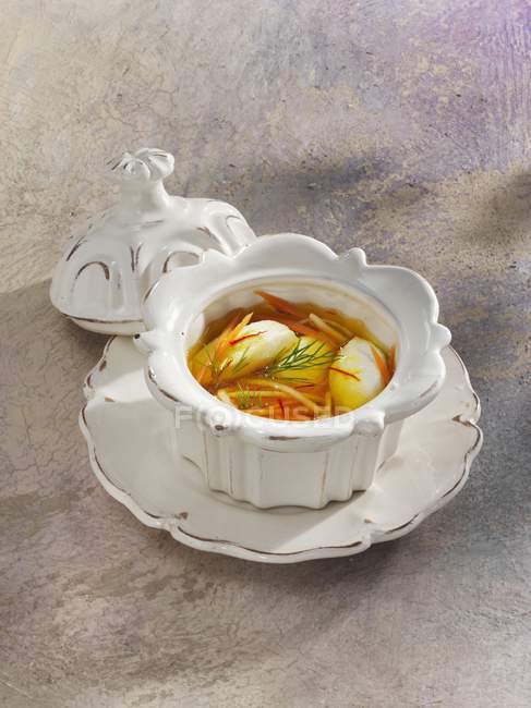 Sopa de merluza Teterow en maceta blanca sobre superficie gris - foto de stock