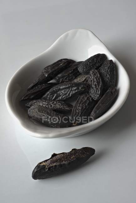 Dried tonka beans in bowl — Stock Photo