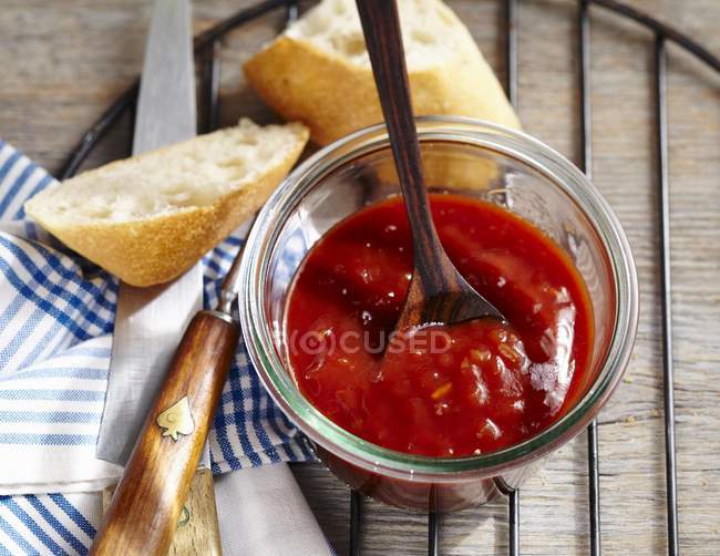 Homemade barbecue sauce in a jar with a spoon — Stock Photo