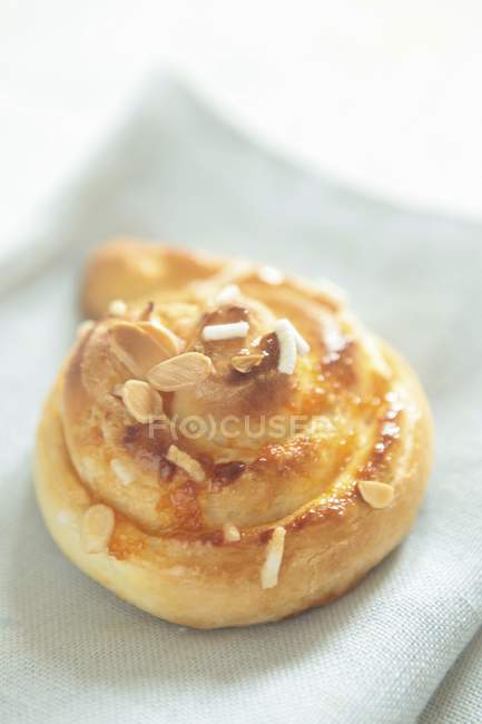 Closeup view of almond Danish pastry on fabric — Stock Photo