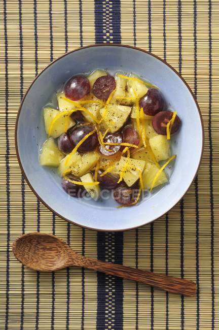 Pineapple salad with grapes and oranges — Stock Photo