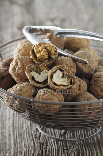 Walnuts in wire basket — Stock Photo