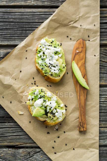 Baguettes with avocado on paper — Stock Photo