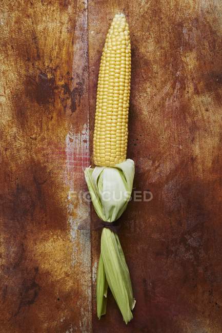 Mazorca de maíz con hojas - foto de stock