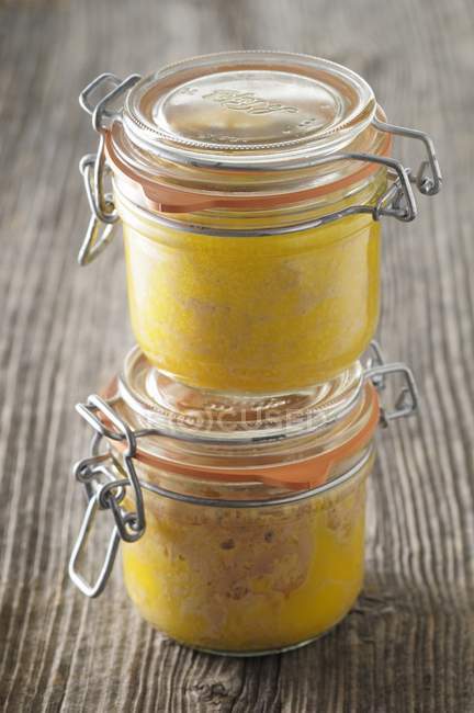 Closeup view of two piled jars of goose liver — Stock Photo