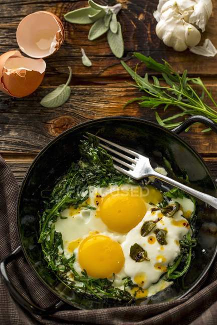 Fried eggs with rocket — Stock Photo