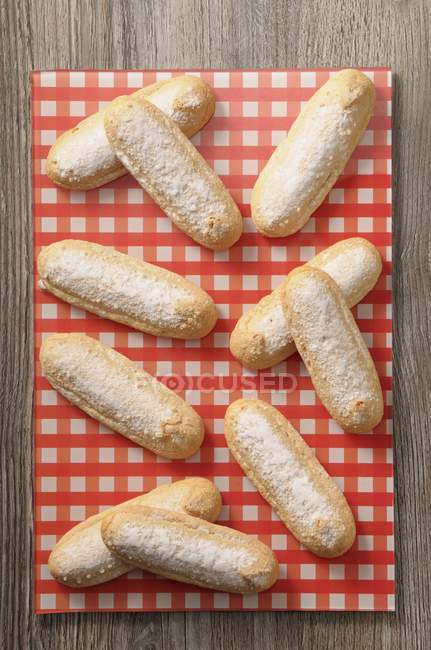 Top view of Sponge fingers on a checkered napkin — Stock Photo