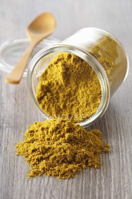 Curry powder in overturned glass — Stock Photo