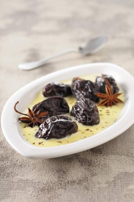 Armagnac plums in vanilla sauce — Stock Photo