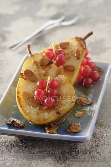 Pears with redcurrant sauce — Stock Photo