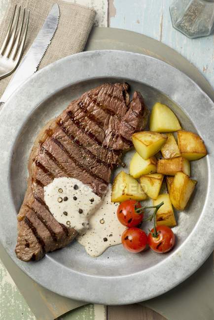Grilled steak with fried potatoes — Stock Photo