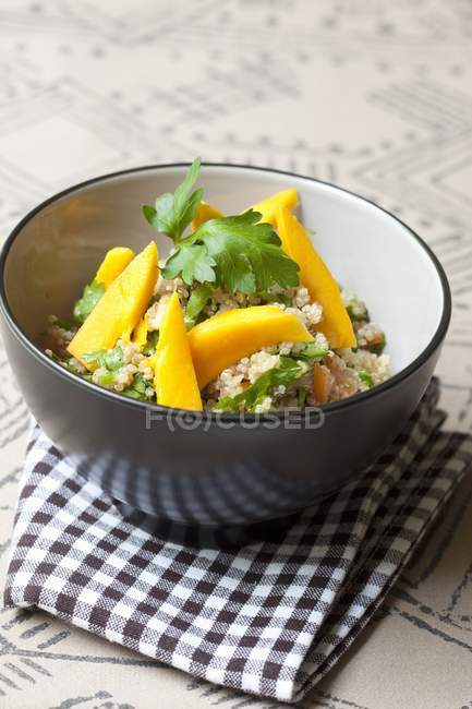 Closeup view of quinoa salad with mango and parsley — Stock Photo