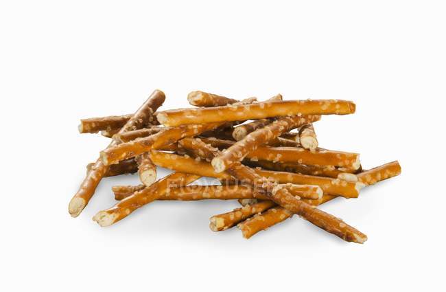 Pile of pretzel sticks on a white surface — Stock Photo