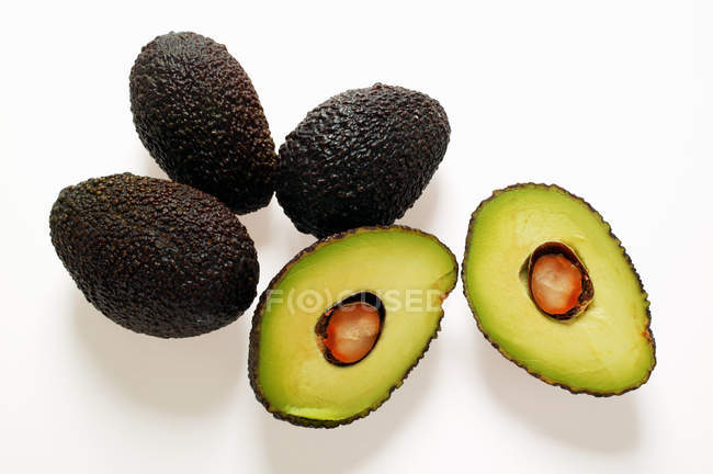 Fresh Mini-avocados with halves — Stock Photo