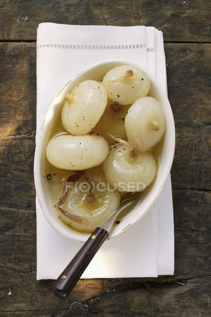 Marinated grilled onions in white dish with fork — Stock Photo