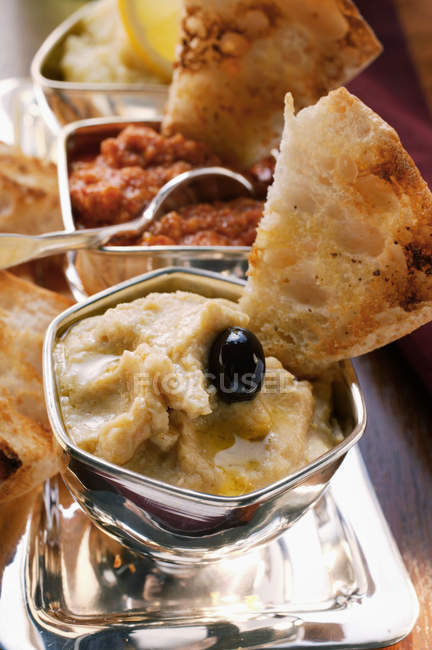 Three spicy dips with toasted white bread — Stock Photo