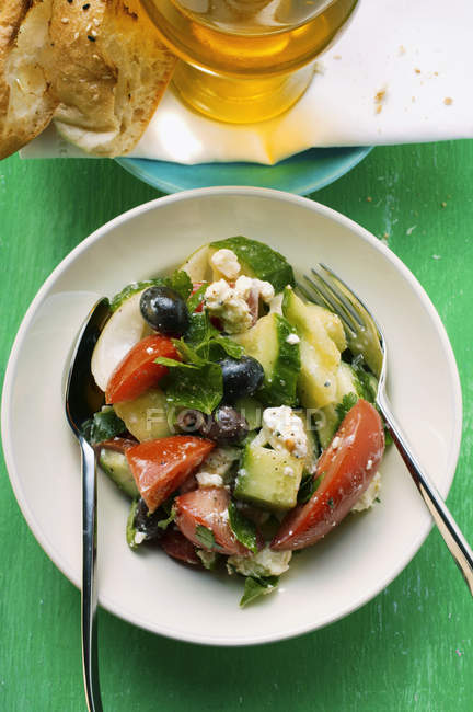 Greek salad with bread — Stock Photo