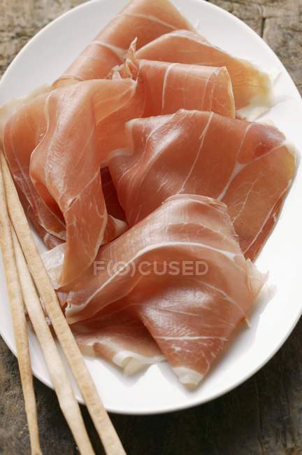 Parma ham with grissini — Stock Photo