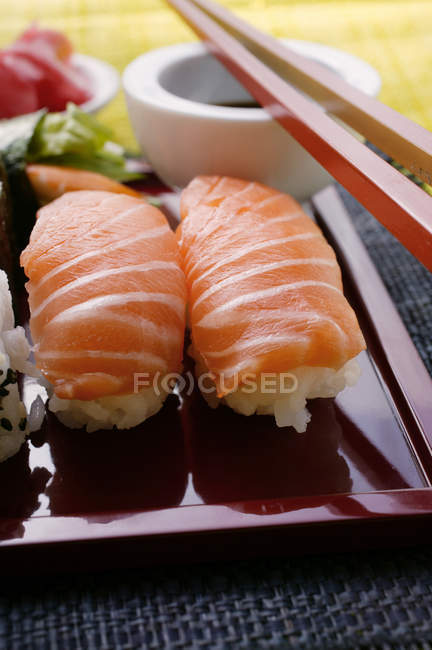 Nigiri sushi on red platter — Stock Photo