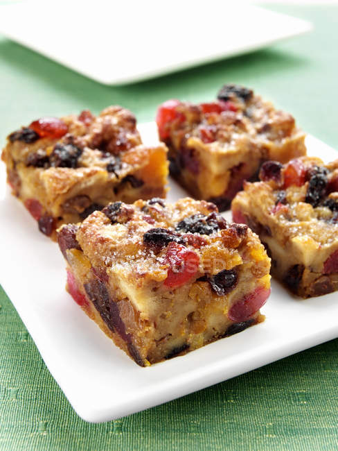 Bread pudding with dried fruits on plate — Stock Photo
