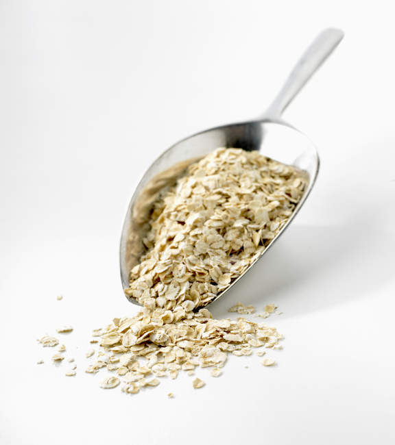 Rolled oats on metal scoop — Stock Photo