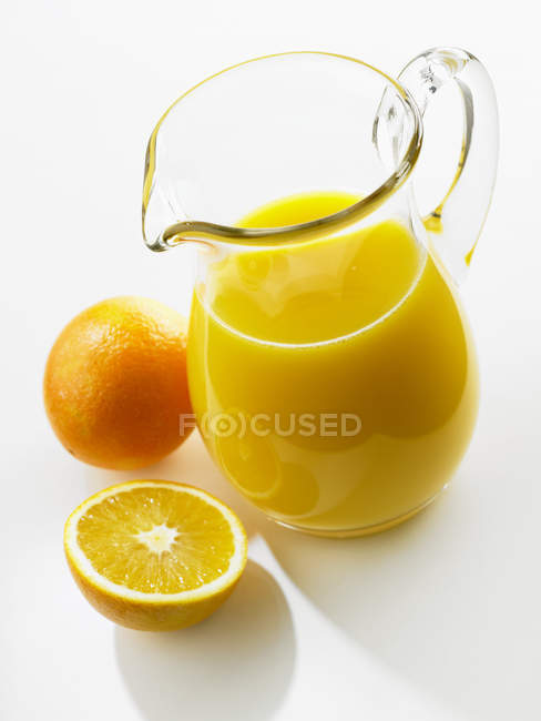 Orange juice in glass jug — Stock Photo