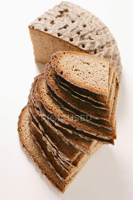 Loaf and slices of bread — Stock Photo