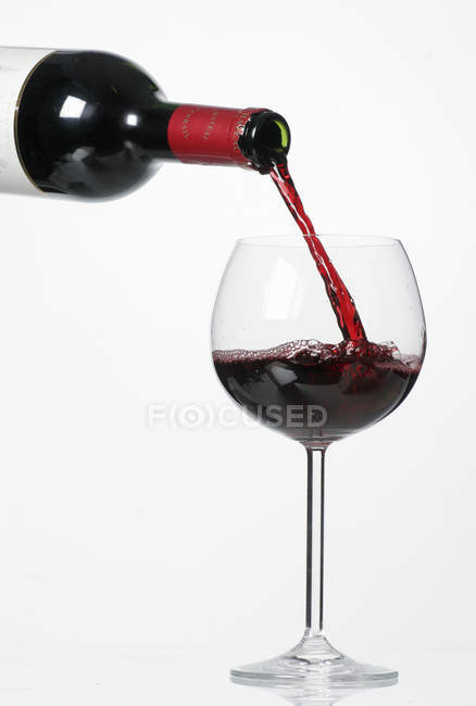 Pouring red wine — Stock Photo