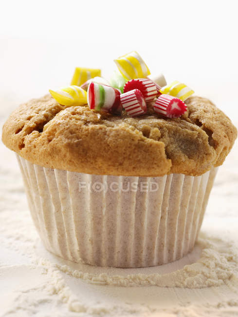 Freshly baked Muffin with candies — Stock Photo