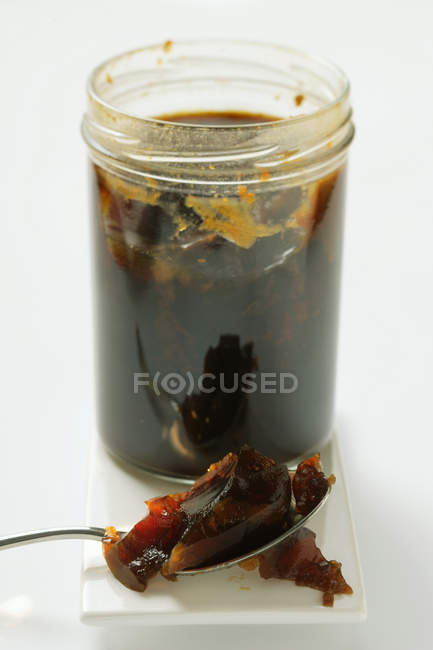 Closeup view of game stock in jar and on spoon — Stock Photo