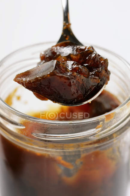 Closeup view of game stock in spoon over jar — Stock Photo
