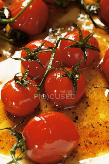 Marinated cherry tomatoes on white surface — Stock Photo