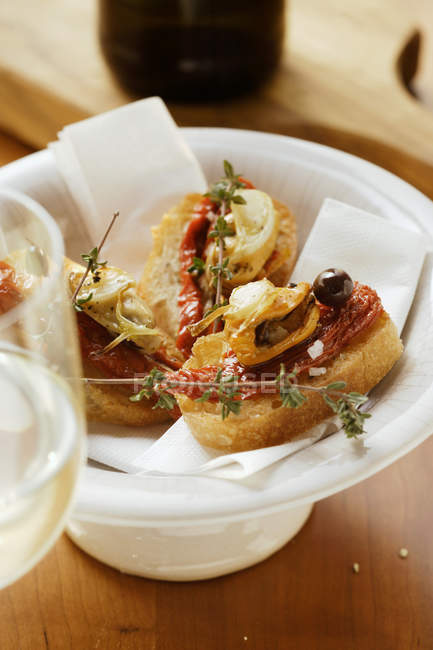 Closeup view of Crostini with seafood and dried tomatoes — Stock Photo