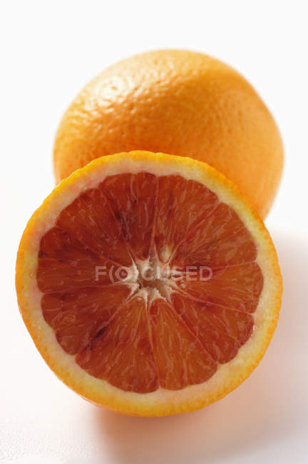 Blood orange with half — Stock Photo